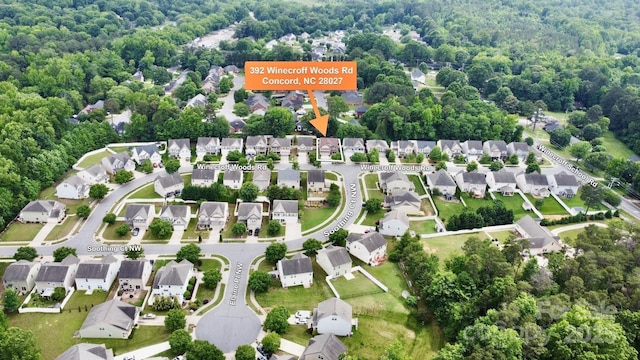 aerial view of residential area featuring a heavily wooded area