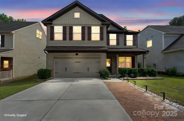 traditional-style house with a garage, a yard, concrete driveway, board and batten siding, and brick siding