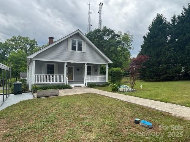 103 Duke St, Great Falls, SC 29055 - bungalow-style house with a chimney, a porch, and a front lawn