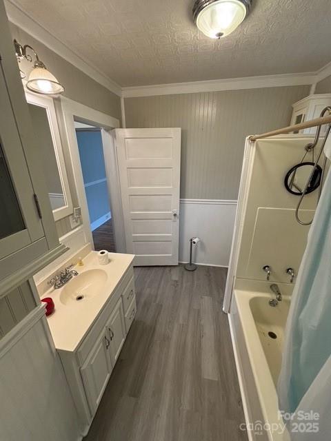 103 Duke St, Great Falls, SC 29055 - full bathroom with wood finished floors, vanity, crown molding, and shower / tub combo with curtain