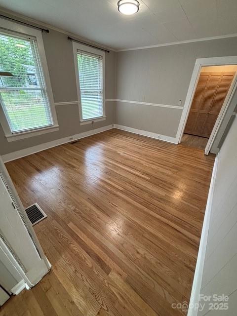 103 Duke St, Great Falls, SC 29055 - empty room with ornamental molding, wood finished floors, and baseboards
