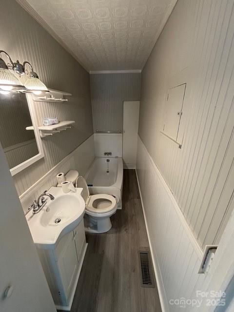 103 Duke St, Great Falls, SC 29055 - bathroom with an ornate ceiling, wood finished floors, vanity, toilet, and crown molding