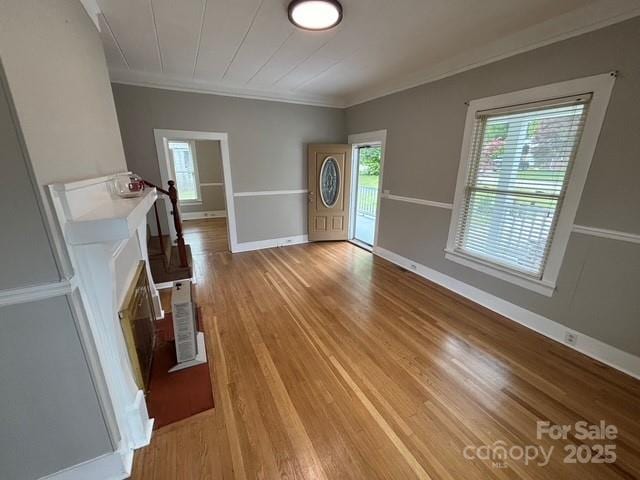 103 Duke St, Great Falls, SC 29055 - unfurnished living room with ornamental molding, light wood-style flooring, and baseboards