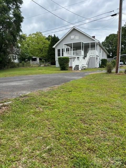 103 Duke St, Great Falls, SC 29055 - view of front of home featuring stairway, covered porch, a front yard, and asphalt driveway