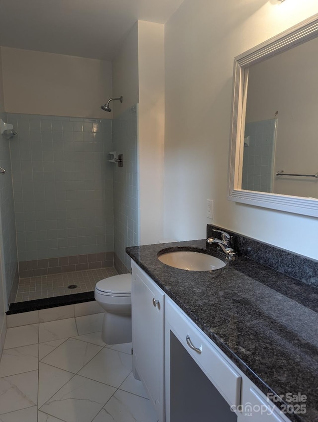 715 Gentry Pl, Charlotte, NC 28210 - bathroom featuring vanity, a tile shower, and marble look tile flooring