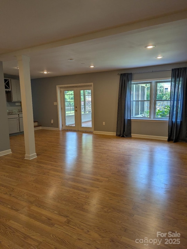 715 Gentry Pl, Charlotte, NC 28210 - unfurnished living room featuring healthy amount of natural light, wood finished floors, recessed lighting, and french doors