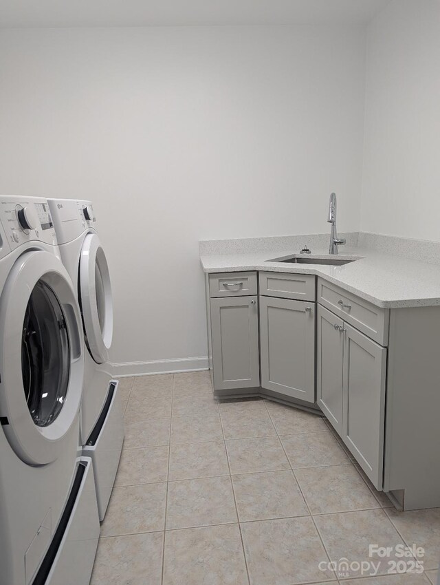 715 Gentry Pl, Charlotte, NC 28210 - laundry room with washer and dryer, light tile patterned floors, and cabinet space