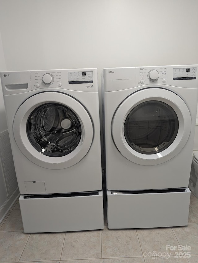 715 Gentry Pl, Charlotte, NC 28210 - laundry area with independent washer and dryer and light tile patterned floors
