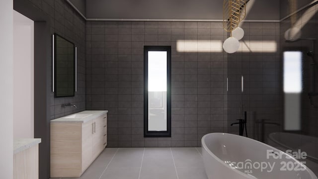 full bathroom featuring tile walls, tile patterned flooring, vanity, and a soaking tub