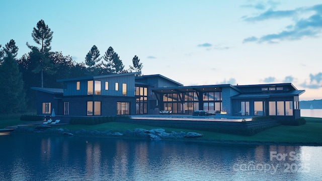 back of property featuring a water view