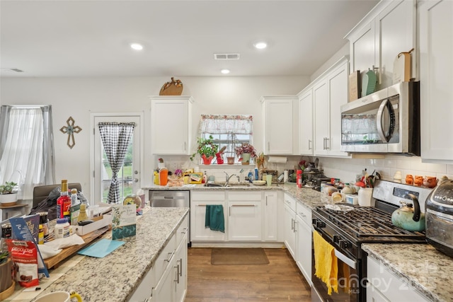3985 Village Blvd NW, Conover, NC 28613 - kitchen featuring stainless steel appliances, healthy amount of natural light, white cabinets, and recessed lighting