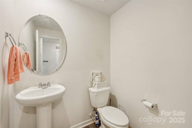 3985 Village Blvd NW, Conover, NC 28613 - bathroom featuring toilet, baseboards, and a sink