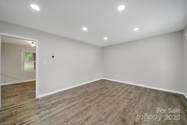 8514 Timber Crest Cir, Charlotte, NC 28226 - empty room with wood finished floors, baseboards, and recessed lighting