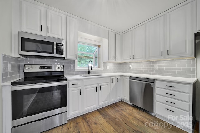 8514 Timber Crest Cir, Charlotte, NC 28226 - kitchen featuring appliances with stainless steel finishes, a sink, white cabinetry, and light countertops