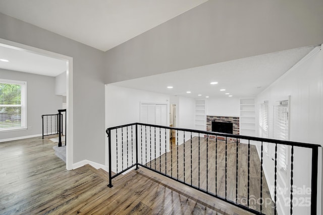 8514 Timber Crest Cir, Charlotte, NC 28226 - hall with an upstairs landing, wood finished floors, baseboards, recessed lighting, and built in shelves