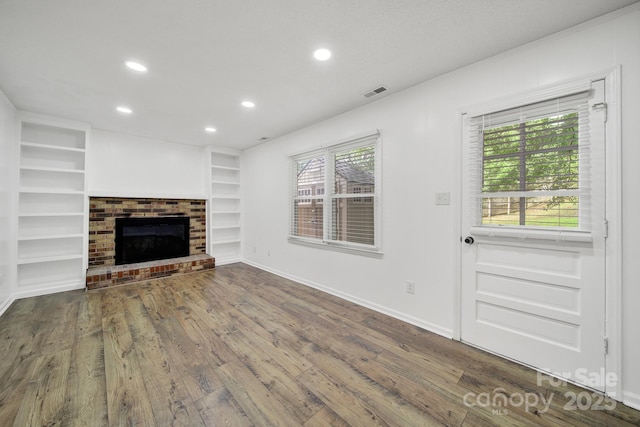 8514 Timber Crest Cir, Charlotte, NC 28226 - unfurnished living room with recessed lighting, wood finished floors, built in shelves, baseboards, and a brick fireplace