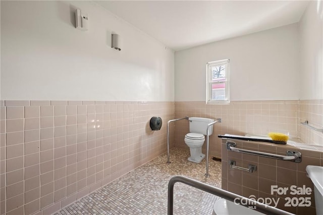 324 Horn Bottom Rd, Forest City, NC 28043 - bathroom with toilet, wainscoting, tile walls, and tile patterned flooring