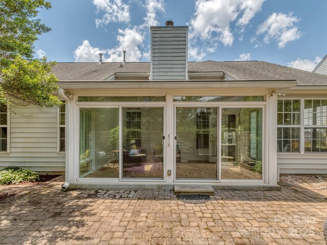 3066 Orion Dr, Fort Mill, SC 29707 - rear view of property with a sunroom, a shingled roof, and a chimney