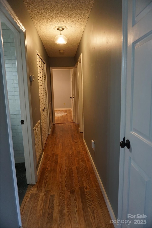 1958 19th Avenue Dr NE Unit 8, Hickory, NC 28601 - corridor featuring a textured ceiling, dark wood-style flooring, and baseboards