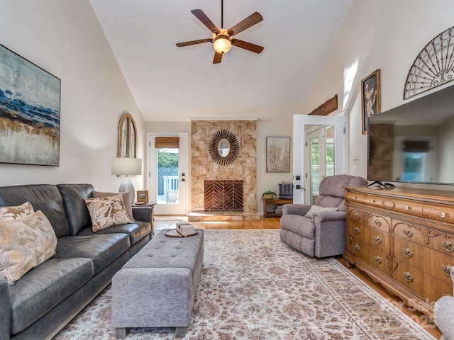 214 Wilcrest Dr, Matthews, NC 28105 - living room featuring high vaulted ceiling, a ceiling fan, wood finished floors, and a stone fireplace