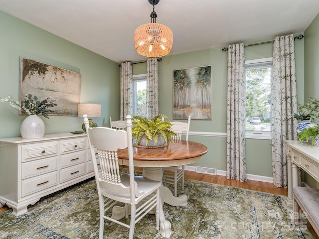 214 Wilcrest Dr, Matthews, NC 28105 - dining space with wood finished floors, healthy amount of natural light, a chandelier, and baseboards
