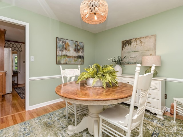 214 Wilcrest Dr, Matthews, NC 28105 - dining area with light wood-style floors, a chandelier, and baseboards