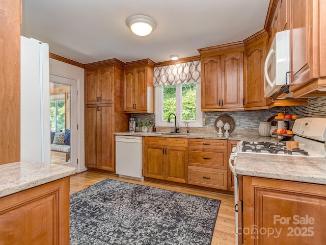 214 Wilcrest Dr, Matthews, NC 28105 - kitchen featuring white appliances, a sink, decorative backsplash, and brown cabinetry