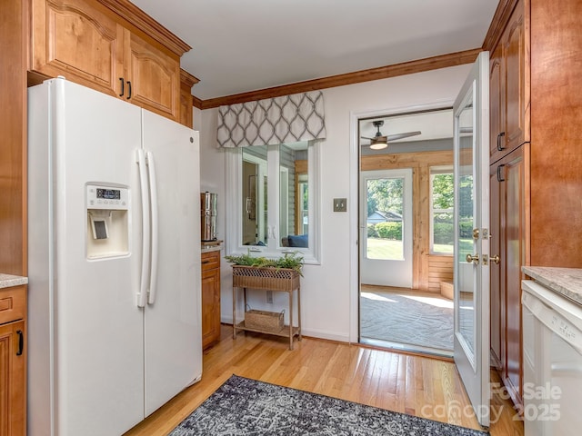 214 Wilcrest Dr, Matthews, NC 28105 - kitchen with white appliances, light wood-style flooring, ceiling fan, brown cabinetry, and ornamental molding