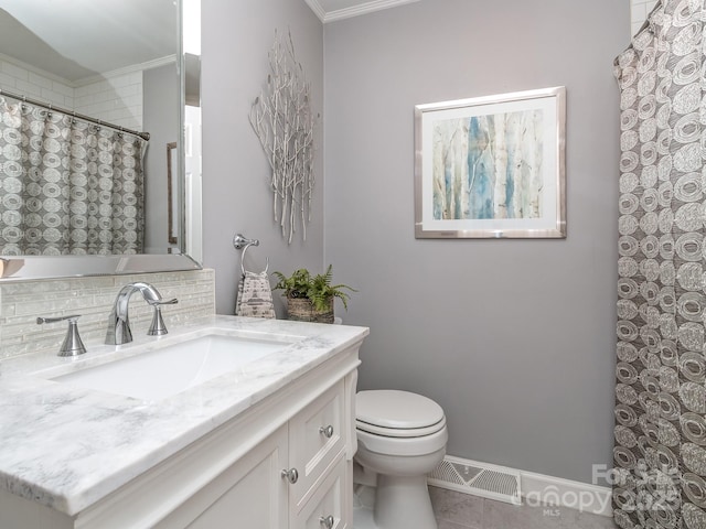 214 Wilcrest Dr, Matthews, NC 28105 - full bathroom with crown molding, toilet, vanity, tile patterned floors, and tasteful backsplash