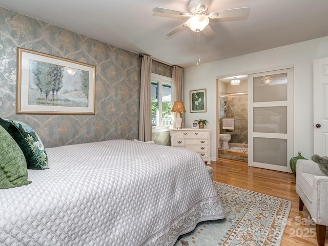 214 Wilcrest Dr, Matthews, NC 28105 - bedroom featuring wood finished floors, ensuite bath, wallpapered walls, baseboards, and ceiling fan