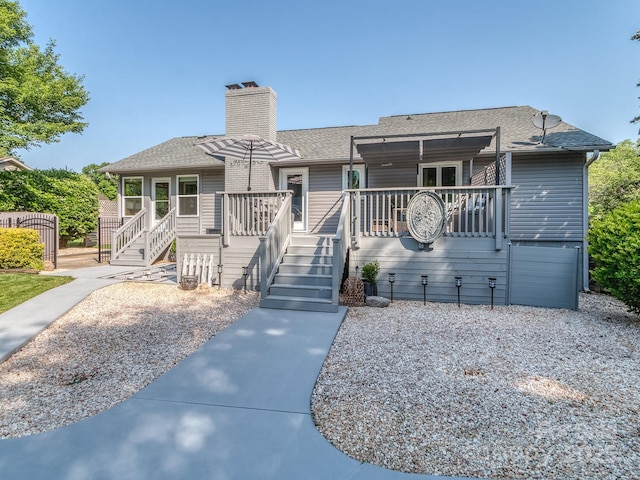 214 Wilcrest Dr, Matthews, NC 28105 - view of front of home featuring a deck, a chimney, a shingled roof, and stairs
