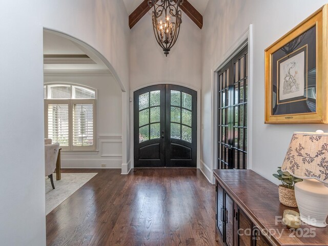1404 Lookout Cir, Waxhaw, NC 28173 - foyer with french doors, arched walkways, dark wood-type flooring, high vaulted ceiling, and a chandelier