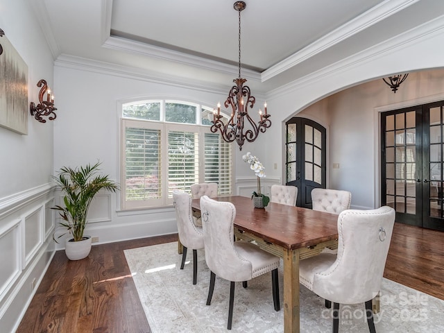 1404 Lookout Cir, Waxhaw, NC 28173 - dining area with french doors, arched walkways, a chandelier, wood finished floors, and crown molding