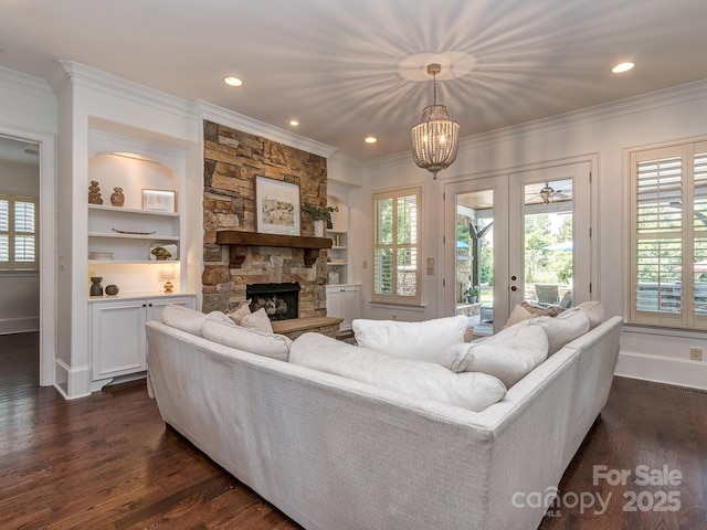 1404 Lookout Cir, Waxhaw, NC 28173 - living area featuring crown molding, a stone fireplace, dark wood-type flooring, plenty of natural light, and recessed lighting
