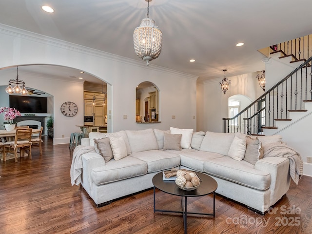 1404 Lookout Cir, Waxhaw, NC 28173 - living room featuring arched walkways, a chandelier, stairway, dark wood finished floors, and recessed lighting