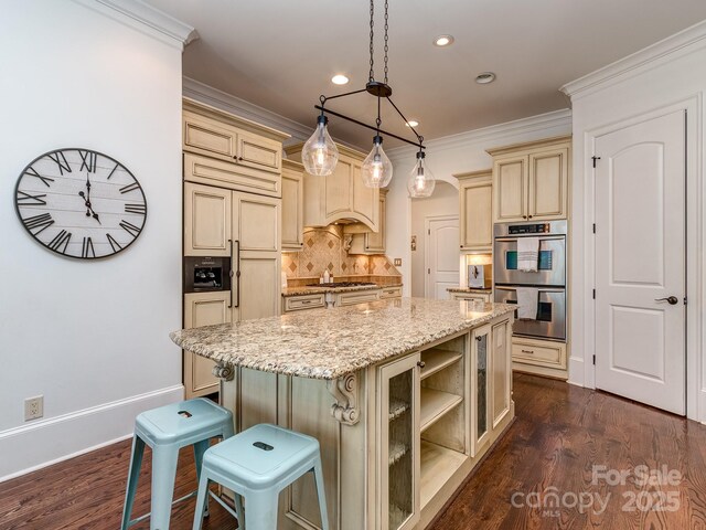 1404 Lookout Cir, Waxhaw, NC 28173 - kitchen with cream cabinets, stainless steel double oven, a center island, backsplash, and light stone counters