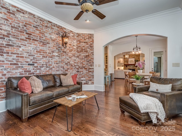 1404 Lookout Cir, Waxhaw, NC 28173 - living room with arched walkways, a ceiling fan, crown molding, wood finished floors, and baseboards