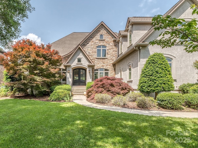 1404 Lookout Cir, Waxhaw, NC 28173 - french country home featuring french doors, stucco siding, a front lawn, and stone siding