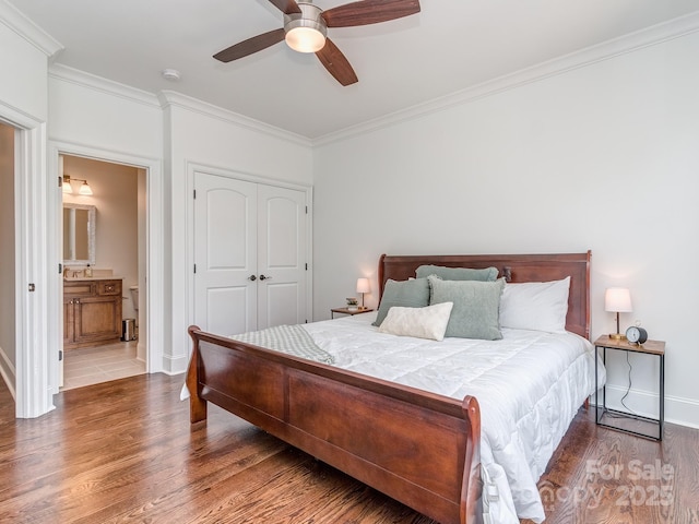 1404 Lookout Cir, Waxhaw, NC 28173 - bedroom with ornamental molding, wood finished floors, baseboards, a closet, and a ceiling fan