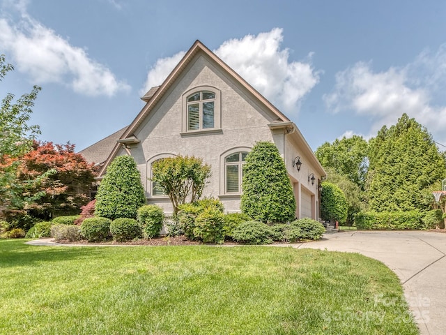 1404 Lookout Cir, Waxhaw, NC 28173 - view of front facade with a garage, a front lawn, stucco siding, and concrete driveway