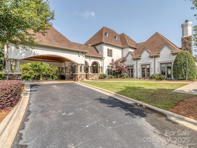 1404 Lookout Cir, Waxhaw, NC 28173 - view of front of property with stucco siding, driveway, a front yard, a chimney, and french doors