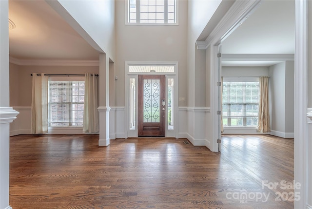 4113 Hoffmeister Dr, Waxhaw, NC 28173 - entrance foyer with wood finished floors, crown molding, decorative columns, a towering ceiling, and baseboards