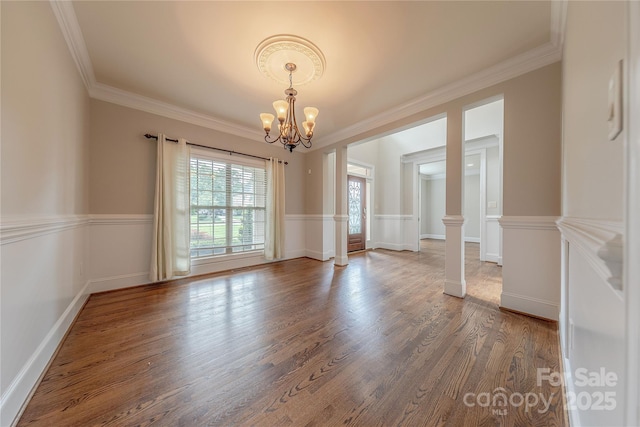 4113 Hoffmeister Dr, Waxhaw, NC 28173 - spare room featuring a chandelier, wood finished floors, ornamental molding, and decorative columns