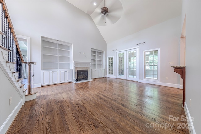 4113 Hoffmeister Dr, Waxhaw, NC 28173 - unfurnished living room featuring a ceiling fan, high vaulted ceiling, built in shelves, baseboards, and wood finished floors