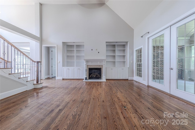 4113 Hoffmeister Dr, Waxhaw, NC 28173 - unfurnished living room featuring high vaulted ceiling, built in shelves, wood finished floors, a premium fireplace, and baseboards