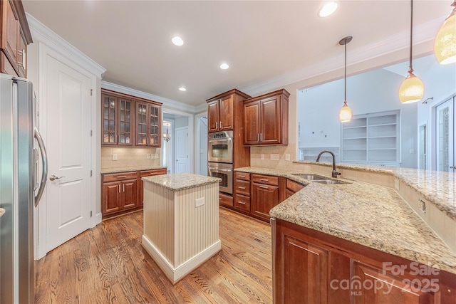 4113 Hoffmeister Dr, Waxhaw, NC 28173 - kitchen with a sink, appliances with stainless steel finishes, light wood-type flooring, tasteful backsplash, and light stone counters