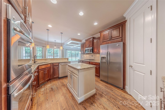 4113 Hoffmeister Dr, Waxhaw, NC 28173 - kitchen featuring stainless steel appliances, a sink, light wood-style flooring, ornamental molding, and recessed lighting