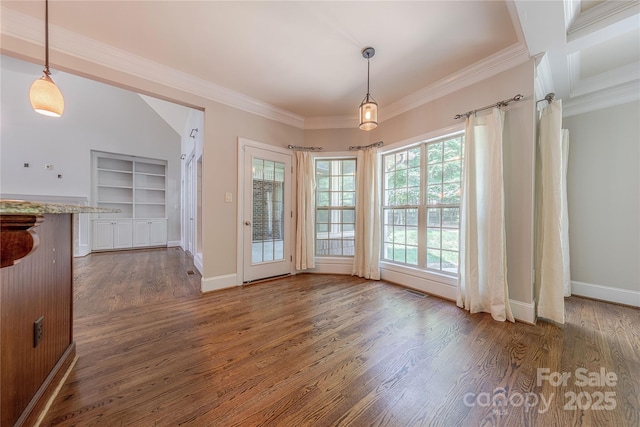 4113 Hoffmeister Dr, Waxhaw, NC 28173 - unfurnished dining area featuring dark wood finished floors, crown molding, baseboards, and built in features