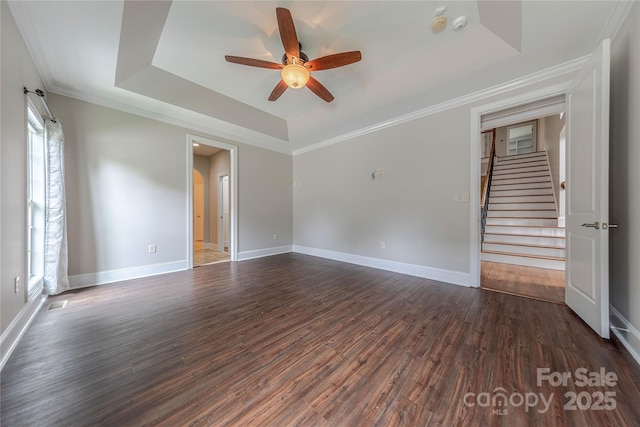 4113 Hoffmeister Dr, Waxhaw, NC 28173 - spare room featuring a tray ceiling, a ceiling fan, dark wood-style flooring, stairs, and baseboards