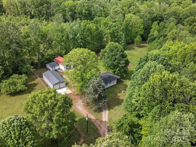 aerial overview of property's location with a heavily wooded area